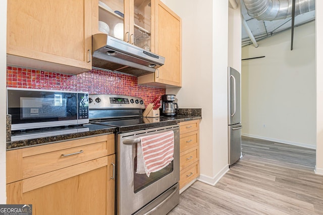 kitchen featuring tasteful backsplash, stainless steel appliances, light brown cabinetry, and light hardwood / wood-style flooring