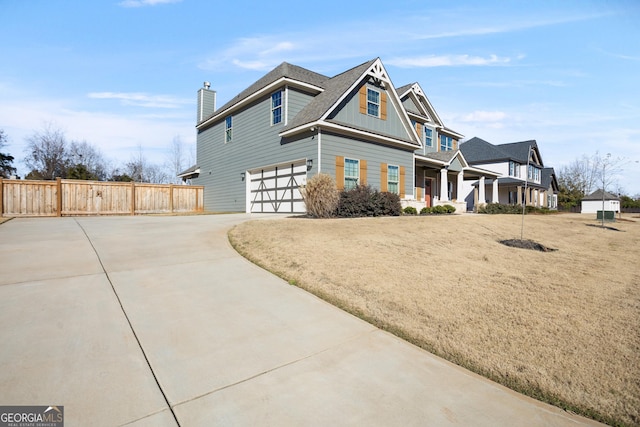 view of front of home with a front yard and a garage