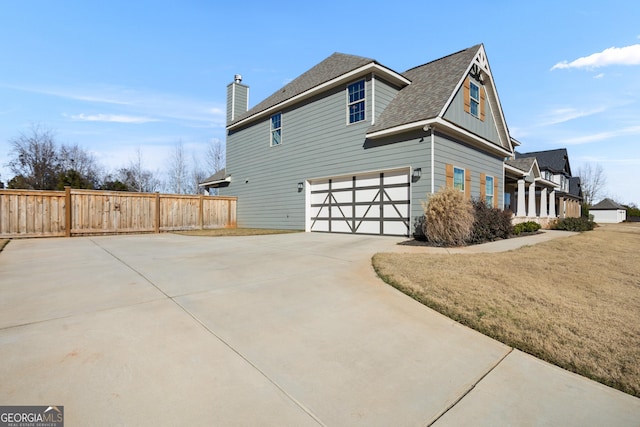 view of home's exterior with a yard and a garage