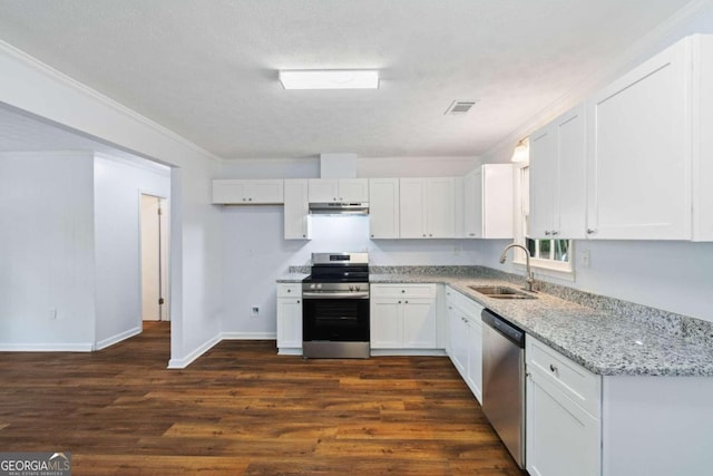 kitchen with light stone countertops, dark hardwood / wood-style flooring, white cabinets, appliances with stainless steel finishes, and sink