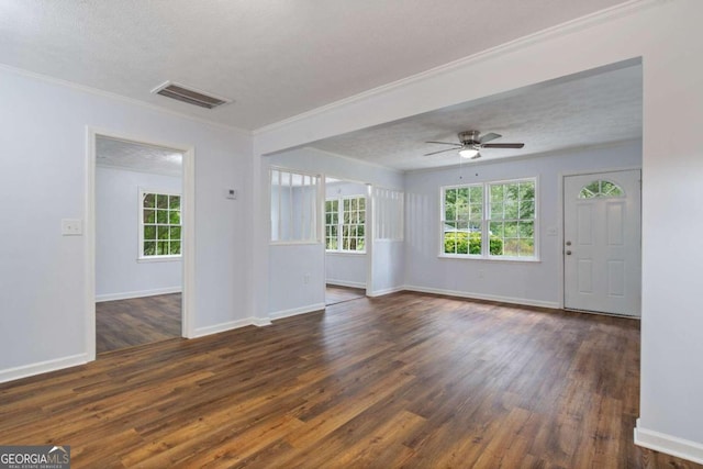 unfurnished living room featuring a textured ceiling, ceiling fan, crown molding, and dark hardwood / wood-style floors