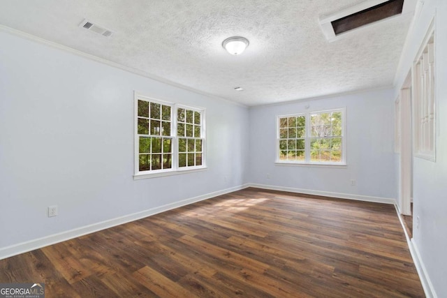 unfurnished room with a textured ceiling, dark wood-type flooring, and crown molding