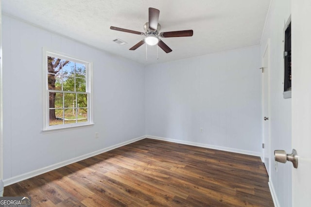 spare room with dark hardwood / wood-style flooring, a textured ceiling, and ceiling fan