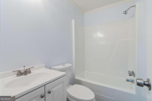 full bathroom featuring toilet, vanity, a textured ceiling, and bathtub / shower combination