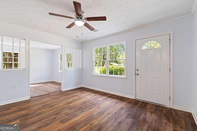 foyer featuring a textured ceiling, ornamental molding, ceiling fan, and dark wood-type flooring