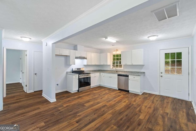 kitchen with dark wood-type flooring, a textured ceiling, appliances with stainless steel finishes, and white cabinetry