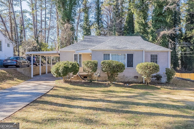 ranch-style home with a carport and a front lawn