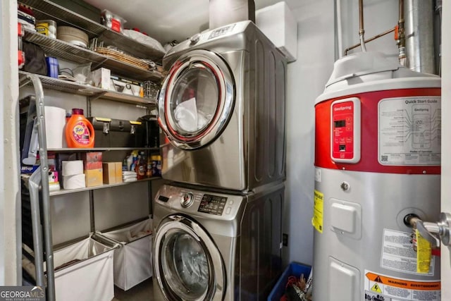 washroom featuring stacked washer and dryer and electric water heater