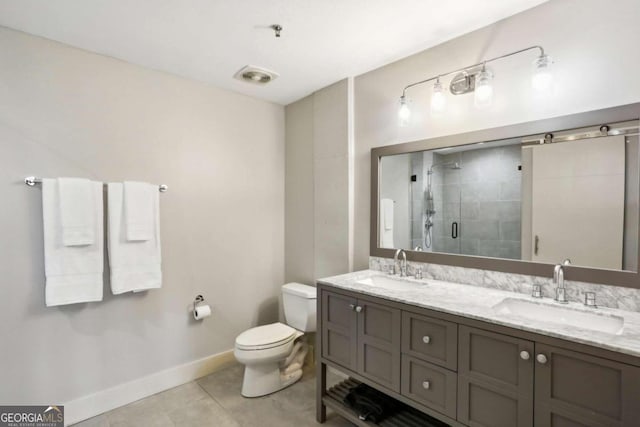 bathroom featuring a shower with door, tile patterned flooring, vanity, and toilet