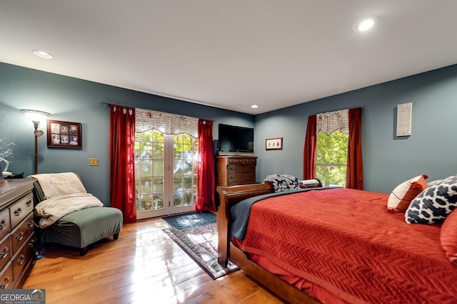 bedroom with access to outside and light wood-type flooring