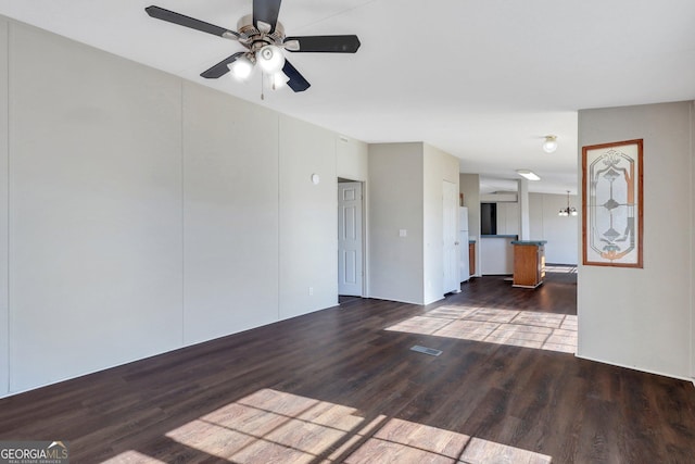 unfurnished living room featuring ceiling fan and hardwood / wood-style flooring