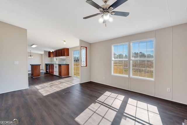 unfurnished living room with dark hardwood / wood-style flooring and ceiling fan