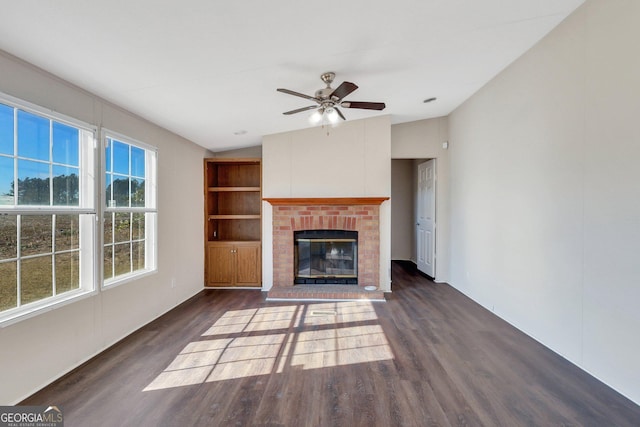 unfurnished living room featuring dark hardwood / wood-style flooring, a brick fireplace, ceiling fan, and vaulted ceiling