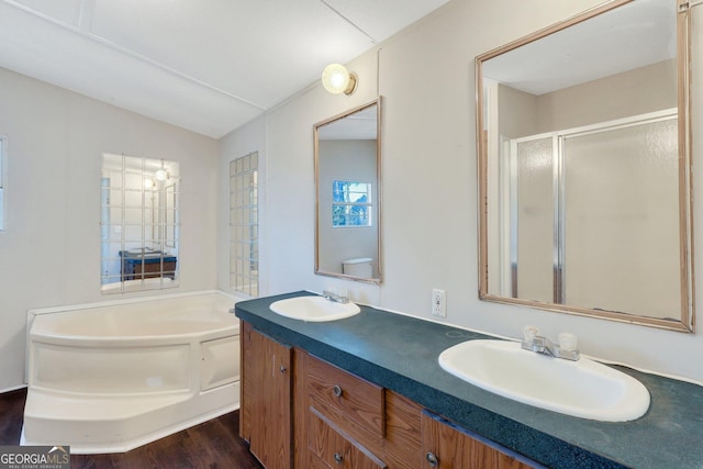 bathroom featuring lofted ceiling, vanity, hardwood / wood-style flooring, and separate shower and tub