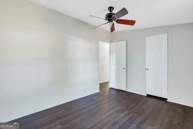 unfurnished bedroom with ceiling fan and dark hardwood / wood-style floors