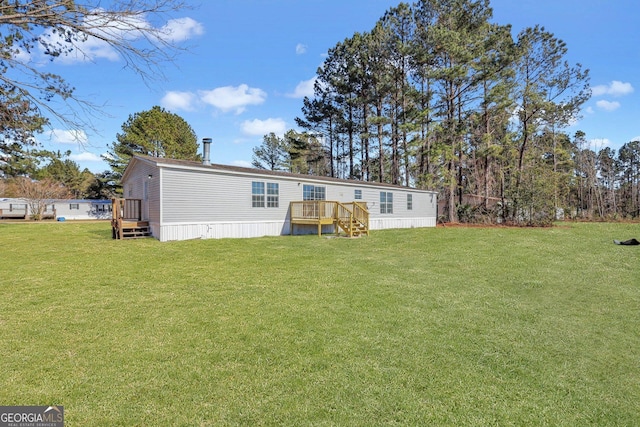 back of house featuring a deck and a lawn