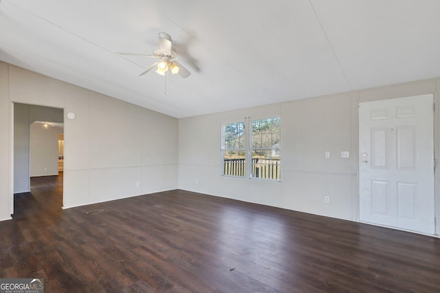 unfurnished room featuring lofted ceiling, dark hardwood / wood-style flooring, and ceiling fan