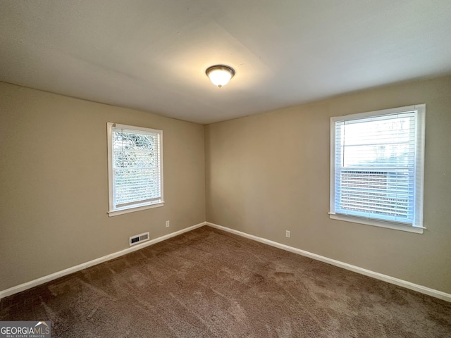 spare room featuring carpet