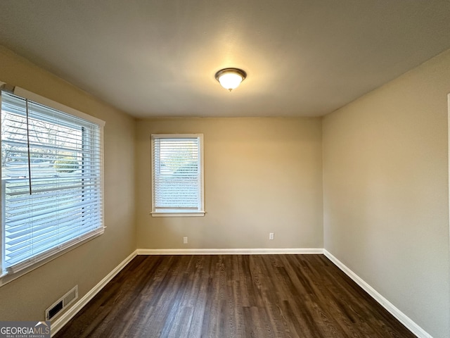 empty room featuring dark wood-type flooring