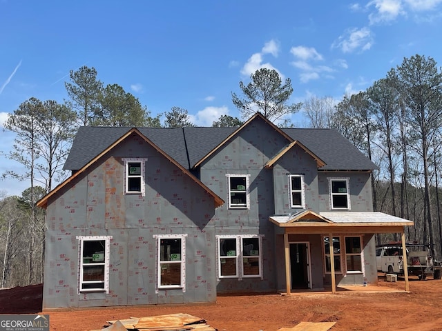 property in mid-construction with a shingled roof and covered porch