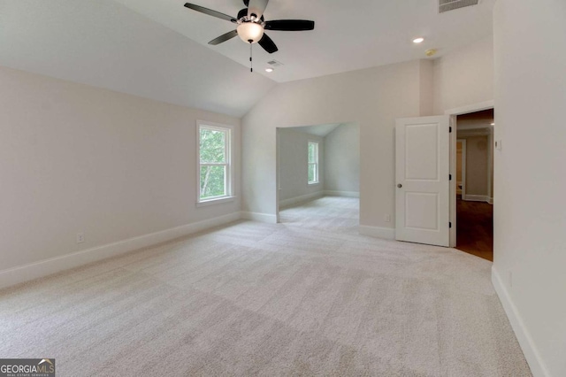 unfurnished bedroom featuring lofted ceiling, light carpet, visible vents, and baseboards