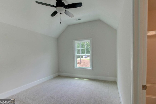 bonus room with carpet floors, a ceiling fan, visible vents, vaulted ceiling, and baseboards