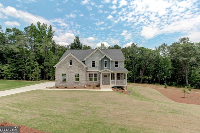 view of front of property with covered porch and a front yard