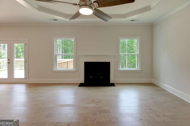 kitchen featuring hanging light fixtures, french doors, wall chimney range hood, a kitchen island, and white cabinetry