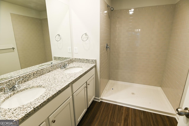 bathroom with a shower, wood-type flooring, and vanity