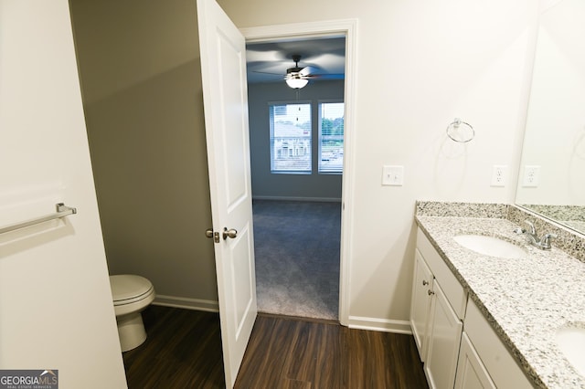 bathroom featuring vanity, hardwood / wood-style floors, toilet, and ceiling fan