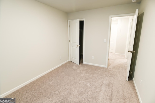 unfurnished bedroom with light carpet