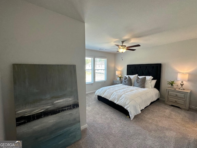 bedroom featuring ceiling fan and carpet