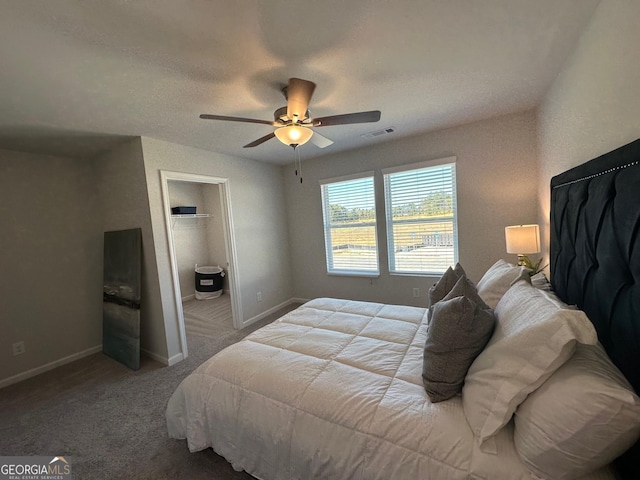 bedroom with light colored carpet, ceiling fan, and connected bathroom