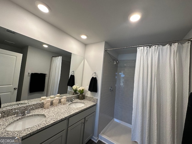 bathroom with a shower with shower curtain and vanity