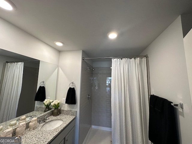 bathroom with curtained shower and vanity