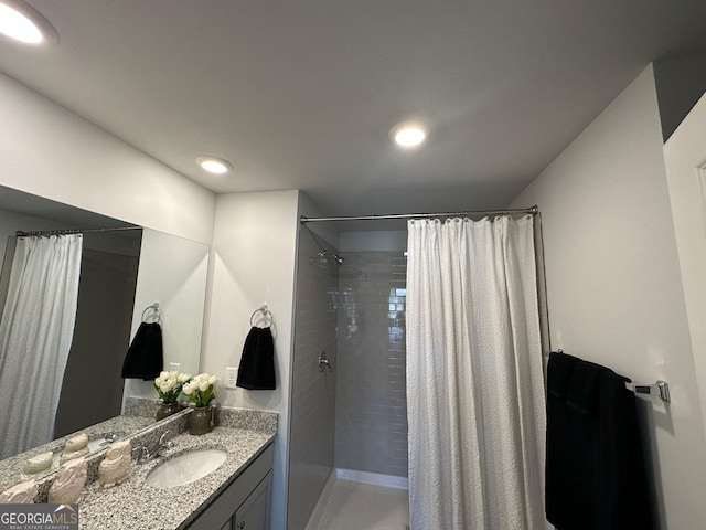 bathroom featuring curtained shower and vanity