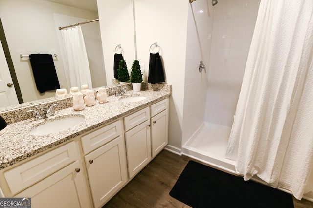 bathroom featuring vanity, curtained shower, and hardwood / wood-style flooring