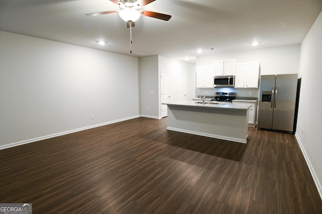 kitchen featuring a kitchen island with sink, dark hardwood / wood-style flooring, white cabinetry, appliances with stainless steel finishes, and sink