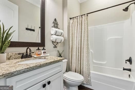 full bathroom featuring toilet, shower / tub combo, and vanity