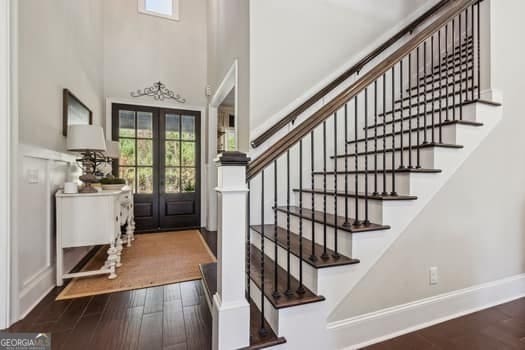 entrance foyer with dark wood-type flooring and french doors