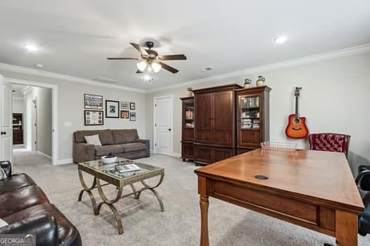 living room featuring light carpet, ceiling fan, and ornamental molding