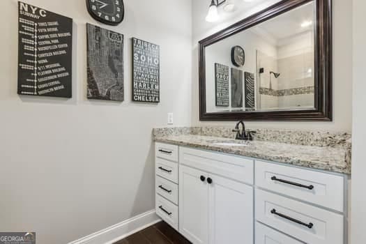 bathroom with hardwood / wood-style flooring and vanity