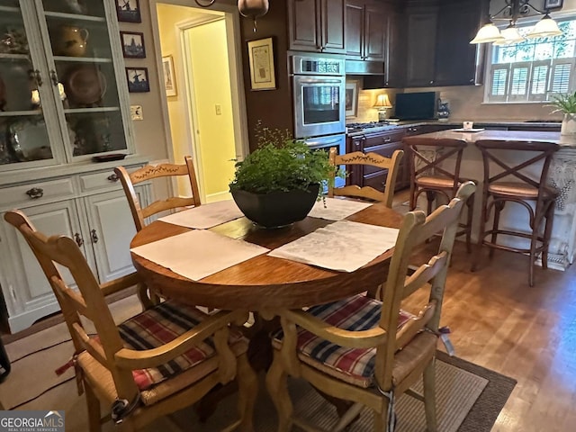 dining space with sink and light hardwood / wood-style floors