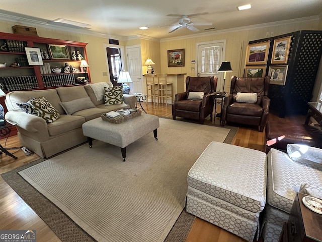 living room featuring ceiling fan, a wealth of natural light, hardwood / wood-style flooring, and ornamental molding