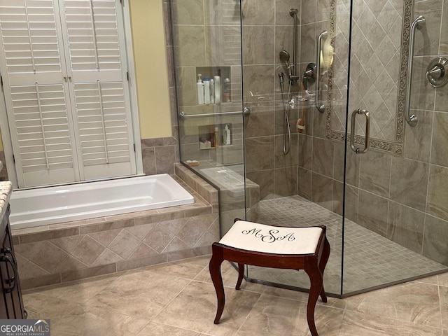 bathroom featuring tile patterned flooring and separate shower and tub