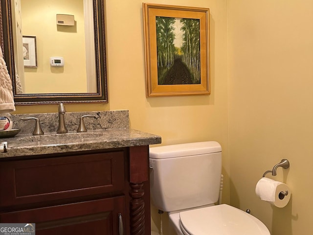 bathroom with toilet and vanity