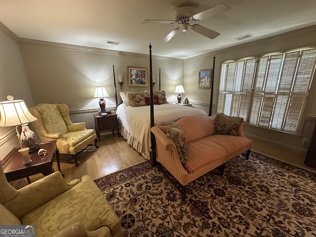 bedroom with ceiling fan, light wood-type flooring, and crown molding