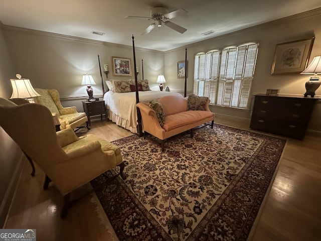 bedroom with ceiling fan, ornamental molding, and hardwood / wood-style flooring