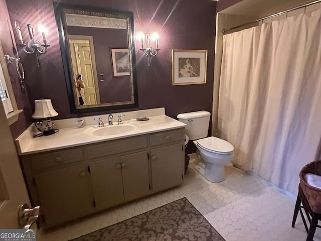 bathroom featuring toilet, tile patterned flooring, and vanity