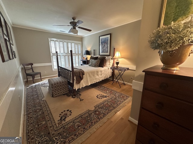 bedroom with ceiling fan, ornamental molding, and light hardwood / wood-style floors